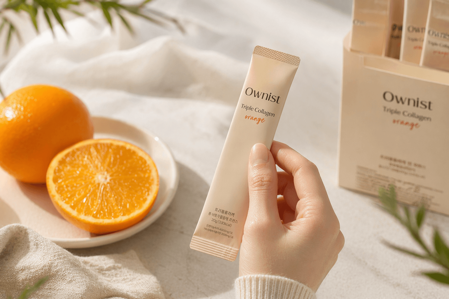 A hand holding an Ownist daily sachet ready to take